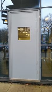 White security door surrounded by glass windows