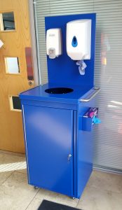 Blue cleaning station with sanitiser paper towel and gloves