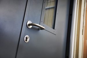 Close up of a steel security door with a sliver handle and lock